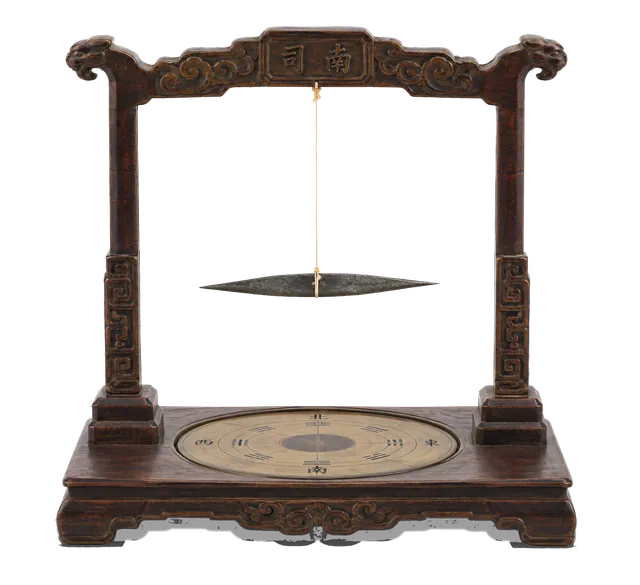 4K transparent cutout of product photography of a single ancient Chinese silk-thread compass featuring a delicate magnetized iron needle suspended by a fine silk thread from a carved wooden stand, isolate…