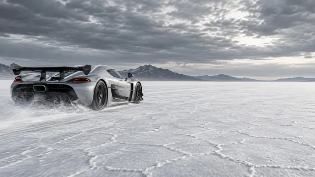 4K wallpaper of Photorealistic automotive photography of a silver Koenigsegg hypercar kicking up faint white dust as it speeds across the salt flats on the left, set against the Bonneville Salt F…