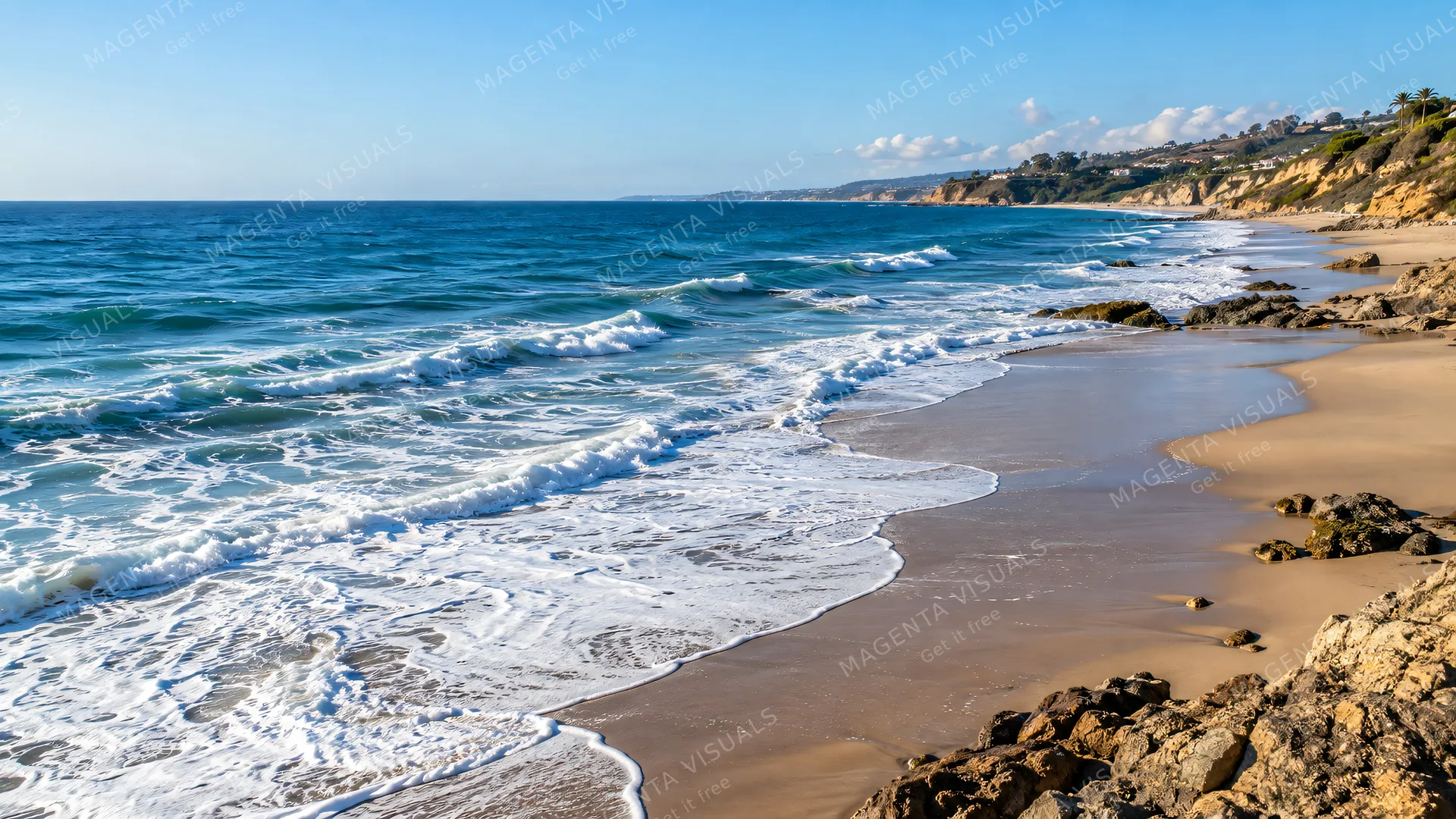 4K 16:9 photoreal photograph of a vast expanse of open ocean meeting the sandy coastline under bright coastal daylight, showcasing a real beach and coast scene.